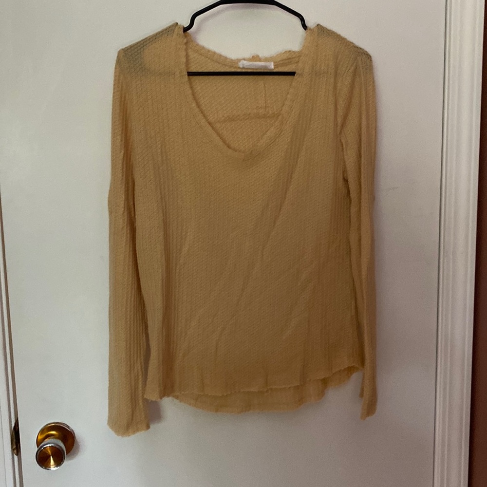 Small mustard yellow long sleeve. Raw hem details on sleeves and bottom.